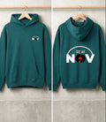 A dark teal-green hoodie shown from both front and back, hanging on wooden hangers against a light gray concrete wall. The front has a small white chest graphic reading 'NOV' with a record label motif, and the back has a large white graphic reading 'DEE JAY NOV' with a vinyl record in the letter O.
