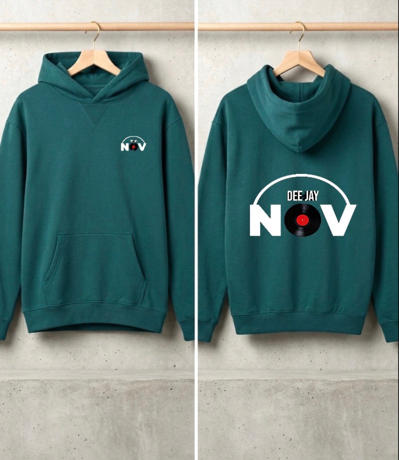 A dark teal-green hoodie shown from both front and back, hanging on wooden hangers against a light gray concrete wall. The front has a small white chest graphic reading 'NOV' with a record label motif, and the back has a large white graphic reading 'DEE JAY NOV' with a vinyl record in the letter O.