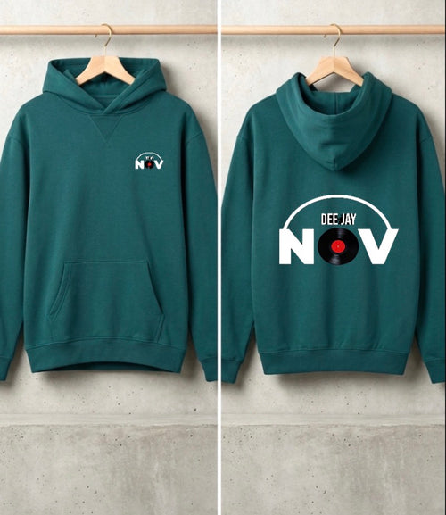 A dark teal-green hoodie shown from both front and back, hanging on wooden hangers against a light gray concrete wall. The front has a small white chest graphic reading 'NOV' with a record label motif, and the back has a large white graphic reading 'DEE JAY NOV' with a vinyl record in the letter O.